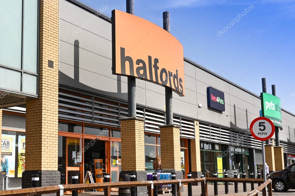 Barry, Wales - March 2021: Exterior view of the entrance to a branch of Halfords on a retail park.
