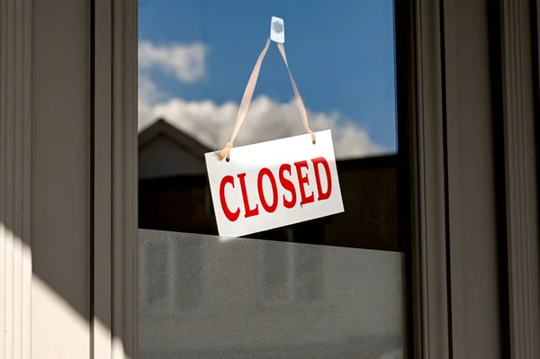 Closed sign in the window of a restaurant which was forced to shut during the national lockdown