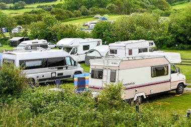 Dorset, England - June 2021: Camper vans on a site on the outskirts of Swanage, Swanage clipart