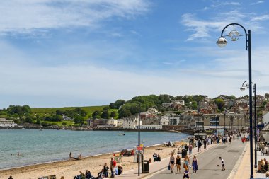 Swanage, İngiltere - Haziran 2021: Swanage 'de deniz kenarında yürüyen insanlar.