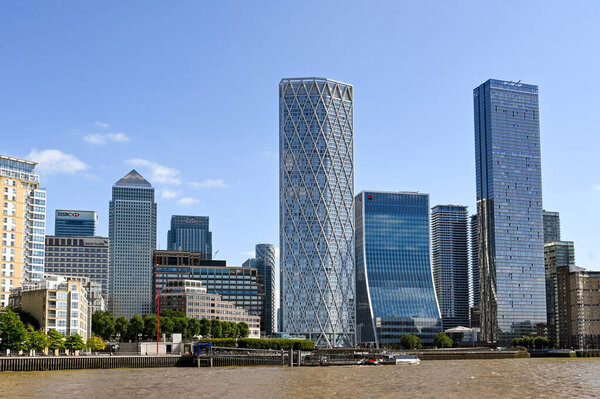London, England - August 2021: Landscape view of skyscraper buildings alongside the River Thames in Canary Wharf