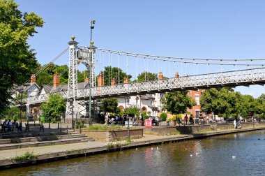 Chester, England - July 2021: Queens Park Bridge 1923 suspension footbridge over the River Dee in Chester. clipart