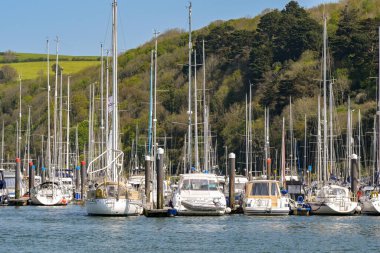 Dartmouth, Devon, İngiltere, İngiltere - 24 Nisan 2025: Dartmouth 'taki Dart Nehri' ne demirlemiş tekne ve yatların manzarası