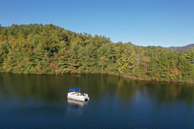 Aerial view of pontoon boat on Lake Santeetlah, North Carolina clipart