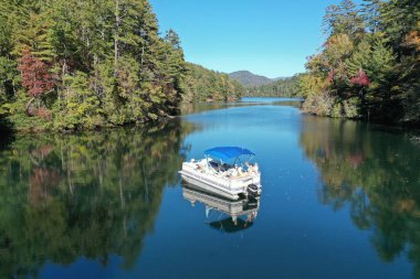 Aerial view of pontoon boat on Lake Santeetlah, North Carolina clipart