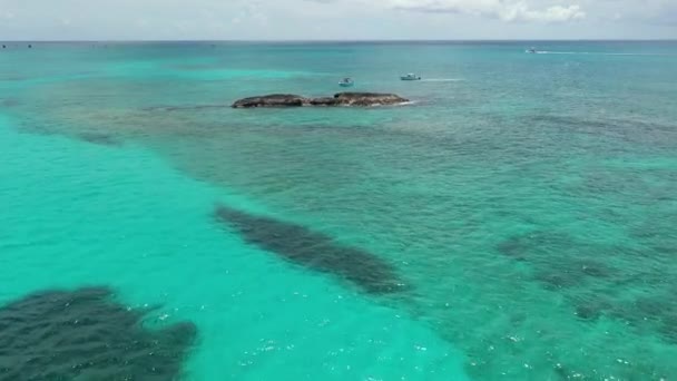 バハマの北ビミニ沖の珊瑚岩の近くに停泊するボートの空中ビュー｜4K. — ストック動画