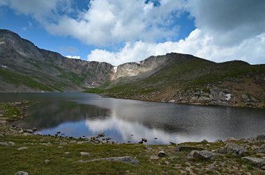 Summit Lake on Mount Evans, Colorado under dramatic summer cloudscape. clipart