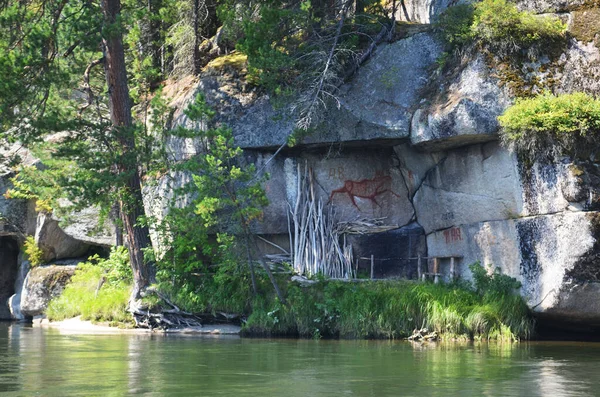 Rock paintings. River and rocks