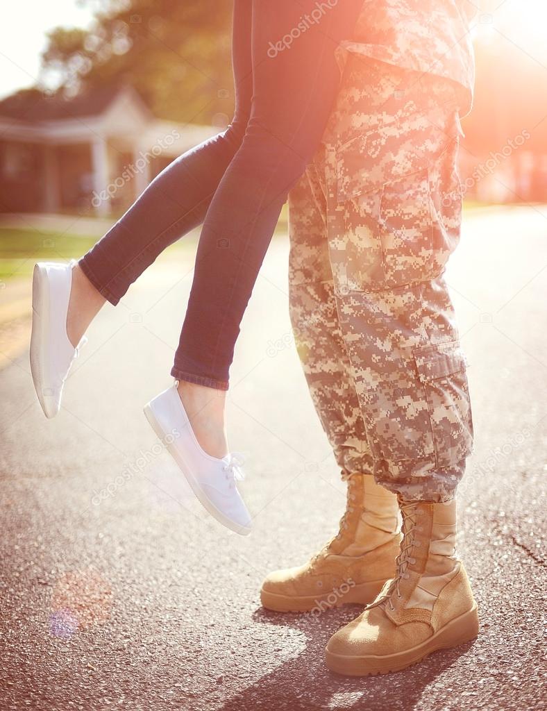 Young military couple kissing each other, homecoming concept, wa