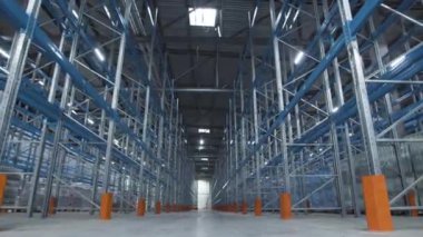 Kamera boş depo rafları arasında ilerler