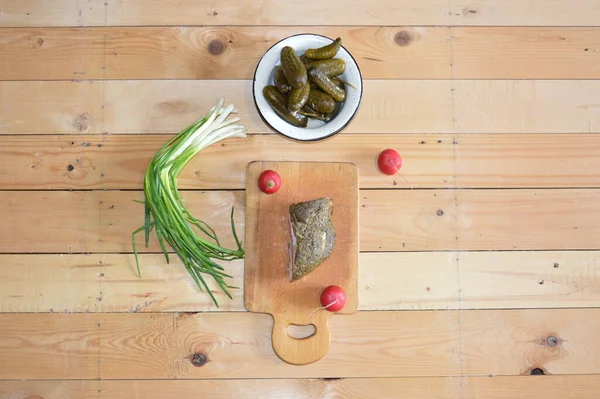 Still life of rustic food from a the fair lard, onions, radishes, cucumbers