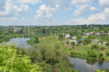 Small town panorama with a river and houses