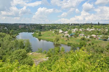 Small town panorama with a river and houses