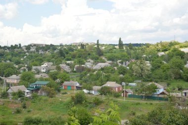 Small town panorama with a river and houses