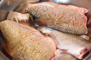 Cut fresh river fish with a the knife