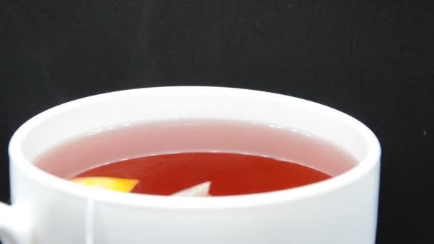 Heated Tea Cools Mixes White Cup Black Background — Stock Video