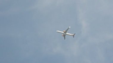 Mavi gökyüzüne karşı bir yolcu uçağı kalkıyor.