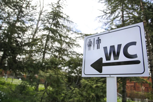 Toilet sign for man and female on white table in nature — Stock Photo, Image