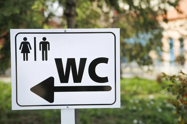 Toilet sign for man and female on white table in nature — Stock Photo, Image