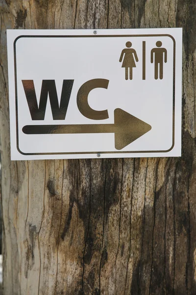 Toilet sign for man and female in white table on wood tree — Stock Photo, Image