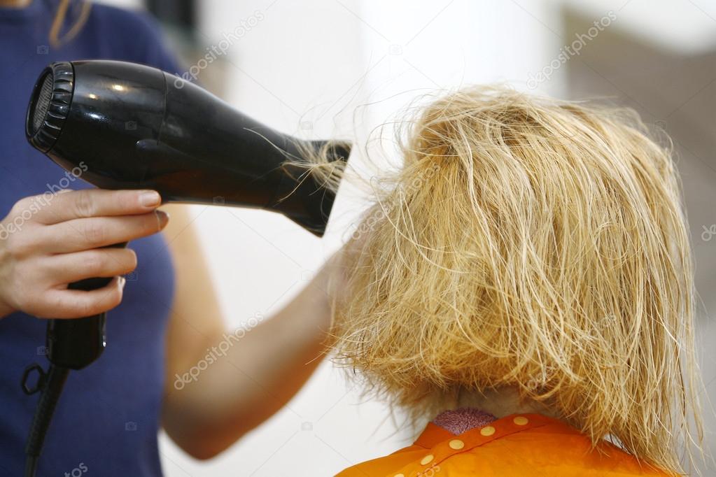 Hairstylist Drying Hair Blonde in Salon