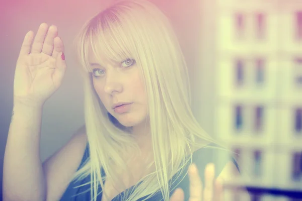 Portrait of beautiful blonde through the glass — Stock Photo, Image