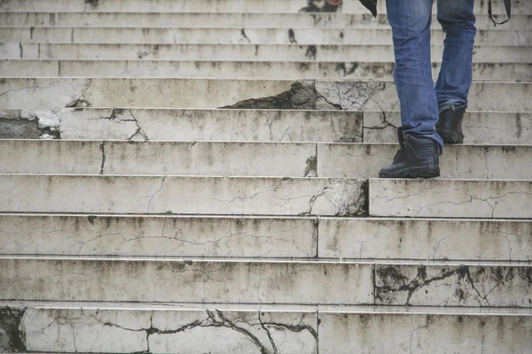 Man walking climb up in old stairs — Stock Photo, Image