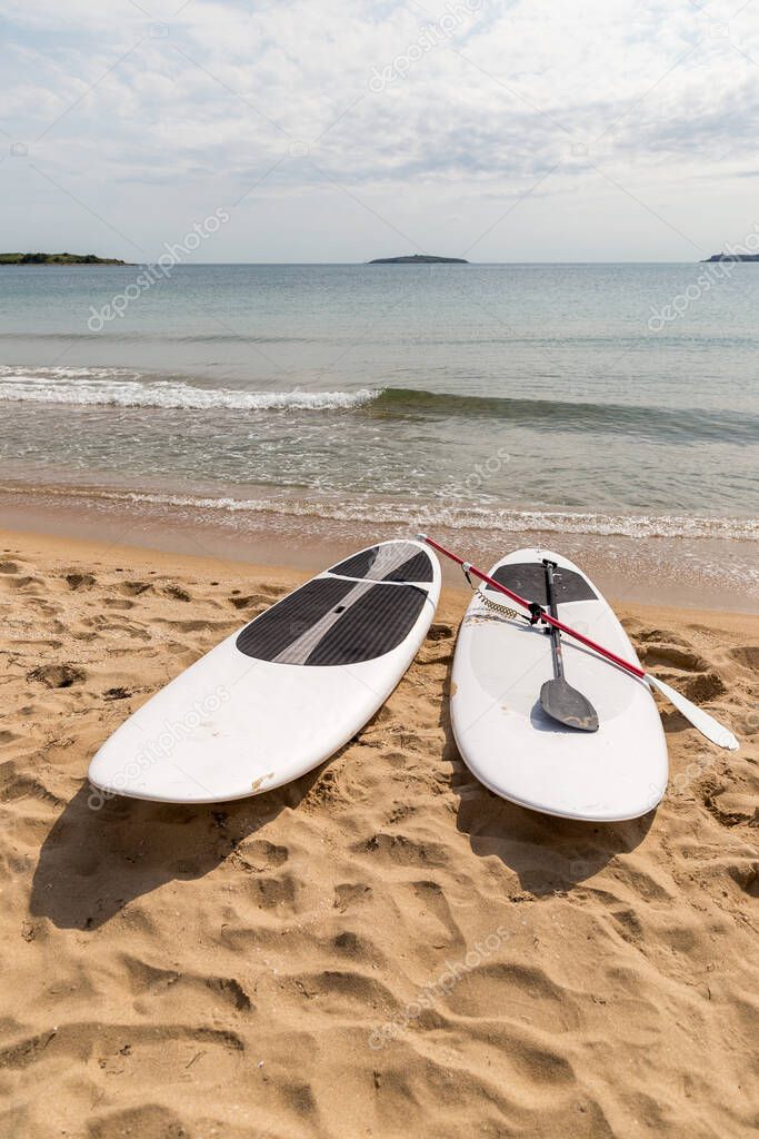 White sunboards lying on a hot sand