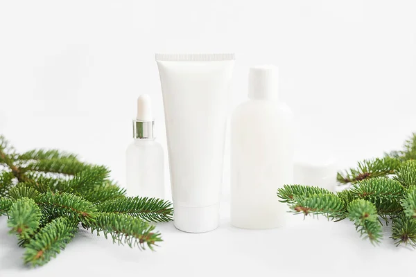 Christmas Beauty cosmetic products sale background. Flat lay composition with makeup products and fir branches on white background. Skin Care & Spa Products. Copy space