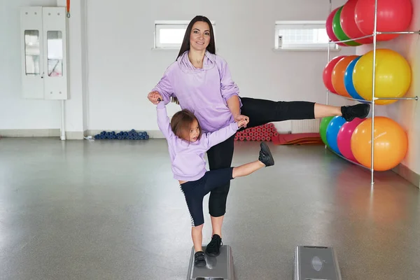 Fitness mother and child. Sports activities with children. Fitness center. Mom and baby gymnastics, yoga exercises. Health and sport concept. Family individual training.