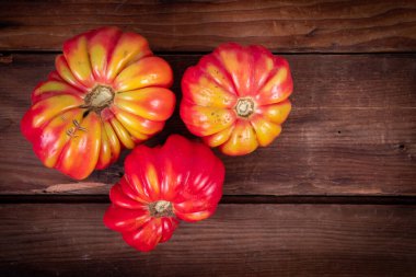 Harvested fresh black cherry cultivar cocktail size tomatoes on a bowl closeup