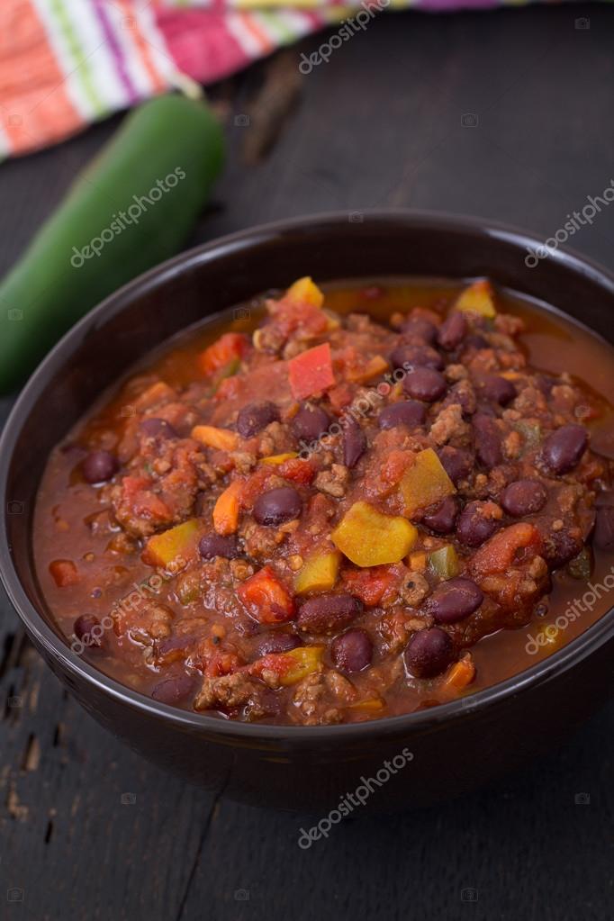 Chili con carne beef chili on black table — Stock Photo © Juliedeshaies