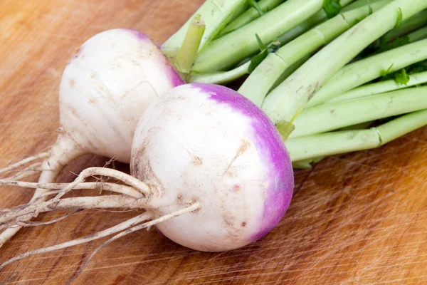 Two organic purple top turnip on table — Stockfoto