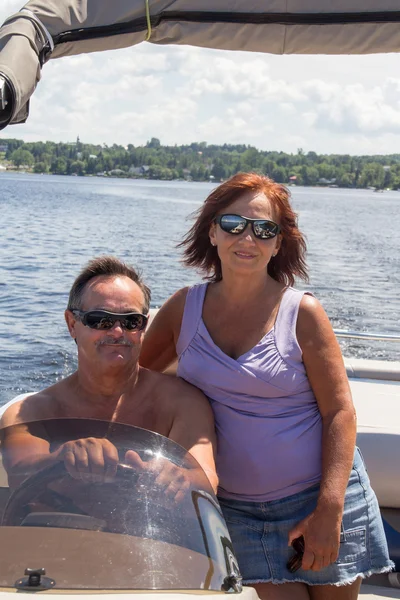 Mature couple on a pontoon boat — Stock Photo, Image