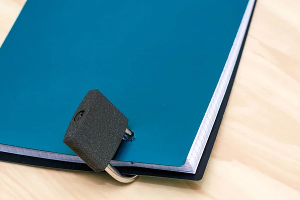 the concept of information protection a closed lock hangs on the notepad for notes