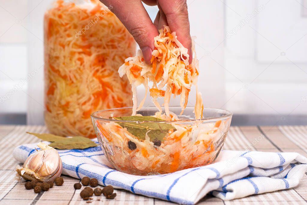 a man eats sauerkraut with his hands from a glass cup. High quality photo