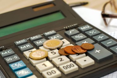 Hesap makinesinin klavyesindeki küçük paralar yakın plan. Yüksek kalite fotoğraf