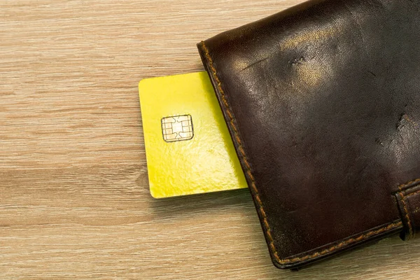 a credit card sticks out of a wallet lying on the copyscape table. High quality photo