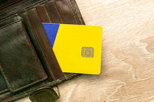 a credit card sticks out of a wallet lying on the copyscape table. High quality photo