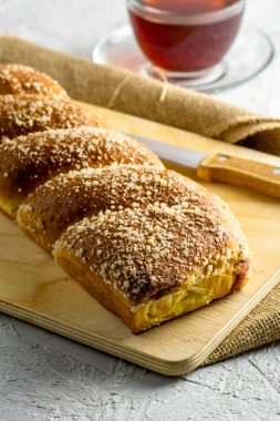 Kirazlı vanilyalı bisküvi bıçağı ve açık gri yüzeyde bir fincan çay. Yüksek kalite fotoğraf