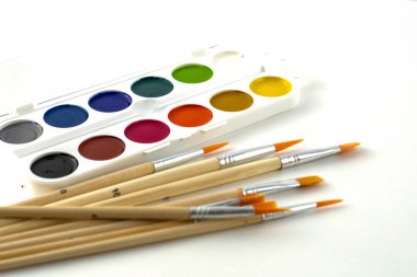 Beyaz arka planda suluboya resimler ve fırçalar. Yüksek kalite fotoğraf