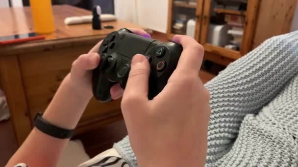 Teenager Plays Game Console Joystick While Sitting Sofa Home Back — Video