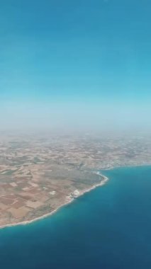 Planes near Larnaca International Airport. Plane flying in blue sky, aircraft landing at airport, passenger transportation beautiful view from window