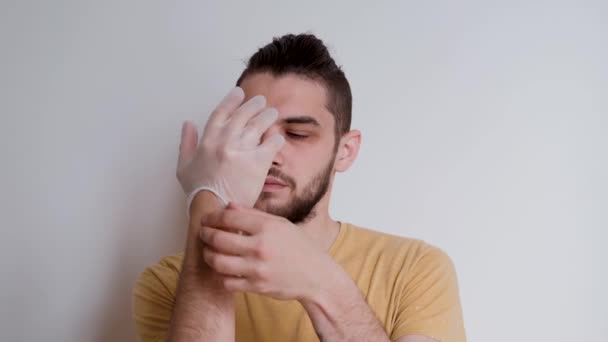 Young Handsome Caucasian Man Beard Puts Transparent Protective Medical Gloves — Stock Video