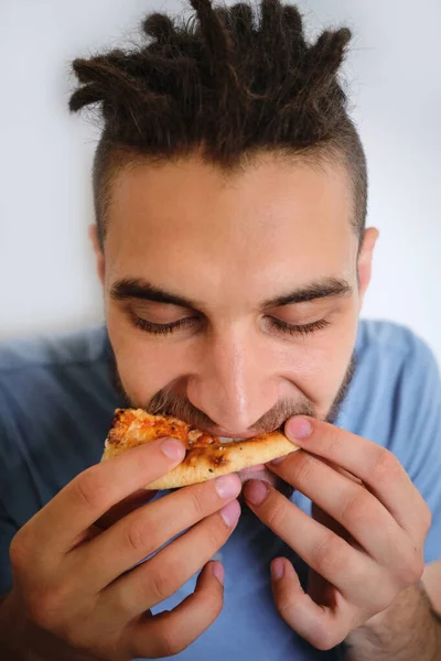 Young Cute Caucasian Man Beard Dreadlocks Eats Pizza White Neutral — Stock Photo, Image