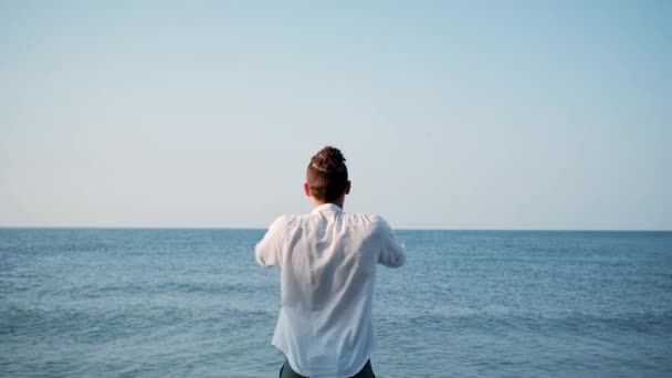 Caucasian Man White Shirt Stands Background Calm Blue Sea Stretches — Stock Video