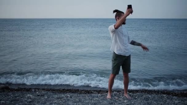 Молодий Кавказький Чоловік Бородою Дредами Білій Сорочці Вушними Навушниками Пляжі — стокове відео