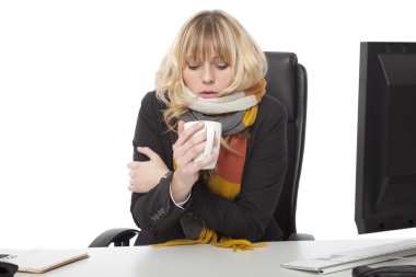 Cold businesswoman drinking a mug of hot coffee clipart