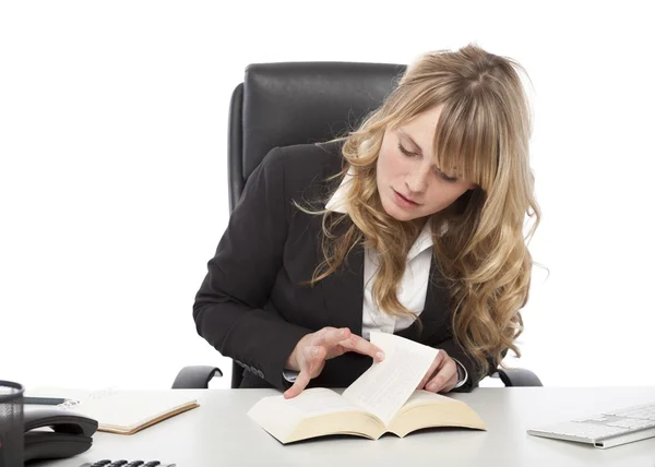Young businesswoman paging through a book — Stock Photo, Image