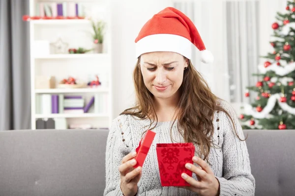 Young girl is sad about christmas gift — Stock Photo, Image